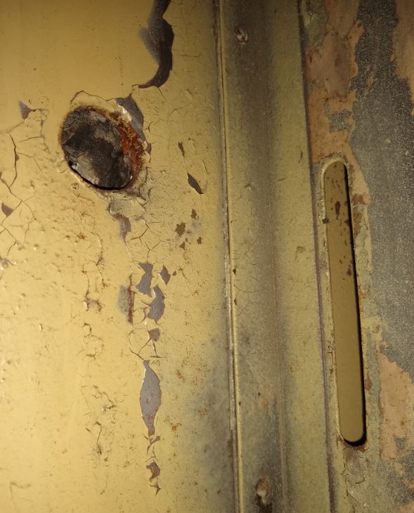 Slot adjacent to door and hole in wall Pullman.JPG